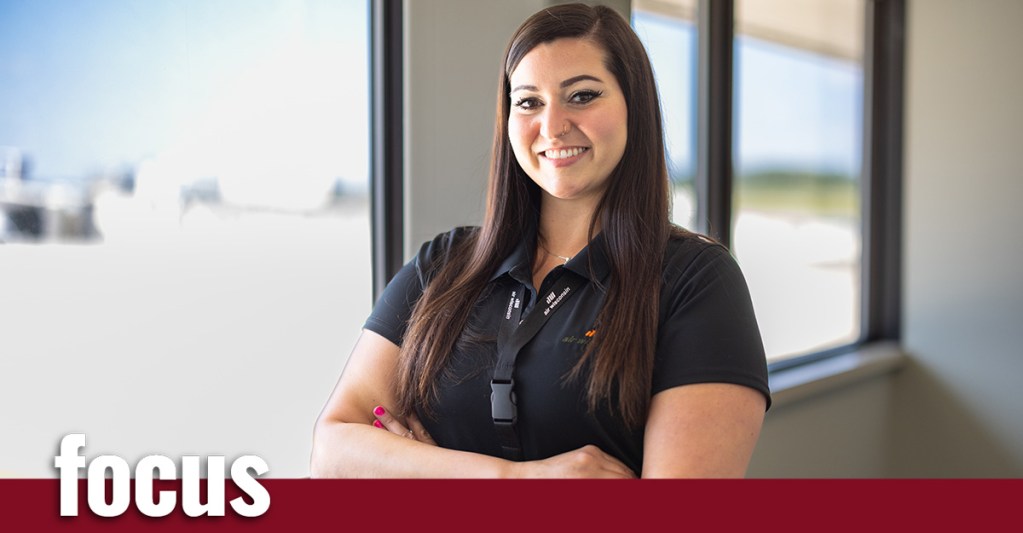 a woman smiling with arms crossed
