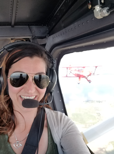 a woman wearing sunglasses and headset in a plane