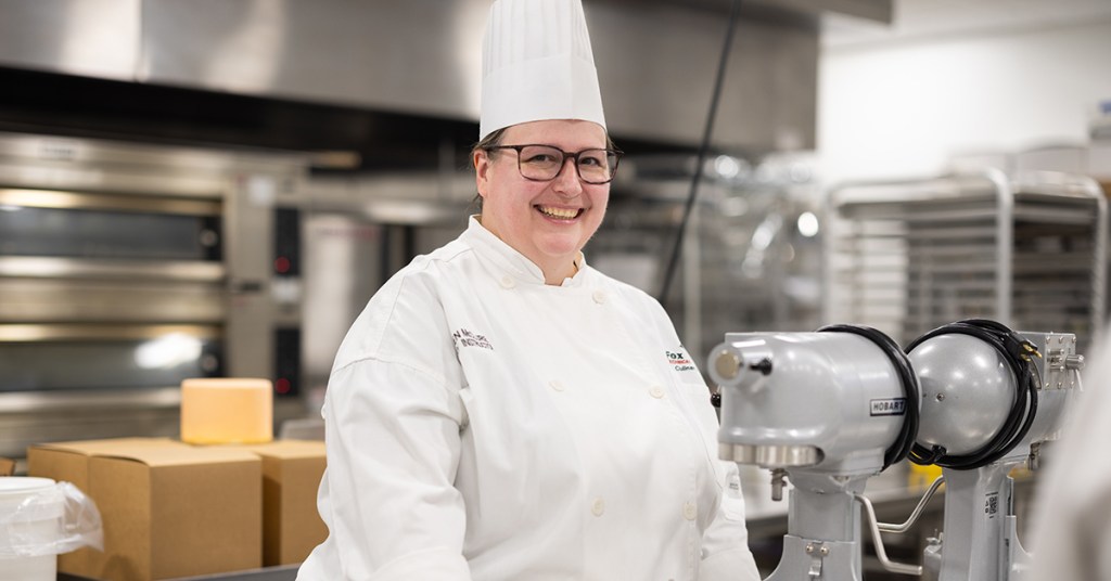 Woman chef standing in a production kitchen