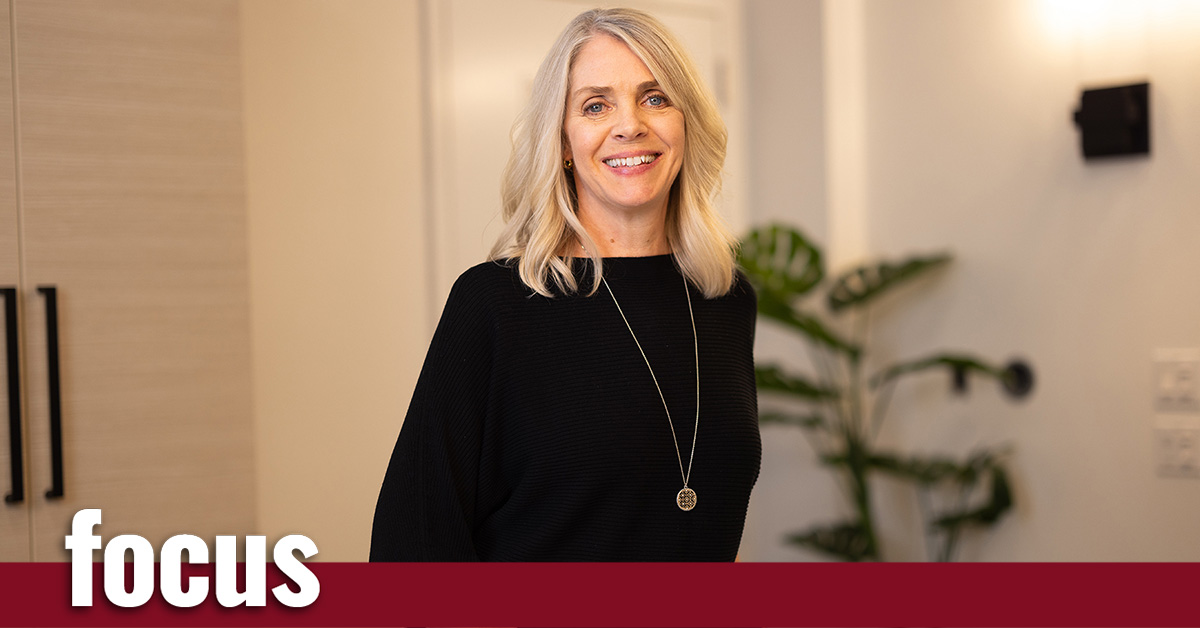 Smiling woman standing in a well-lit room