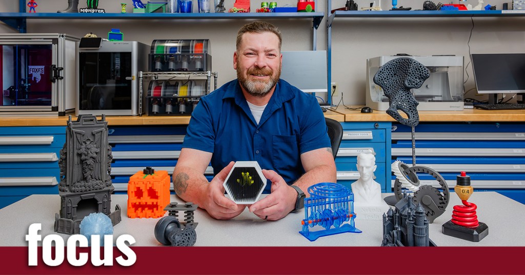 A man sitting in a room with 3D printed objects