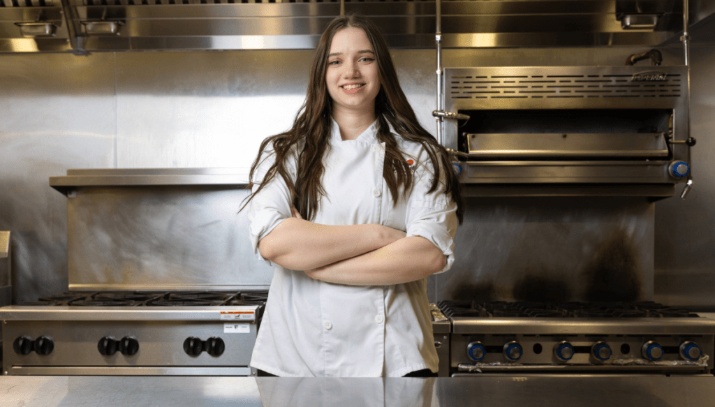 Culinary student in a culinary lab in uniform.