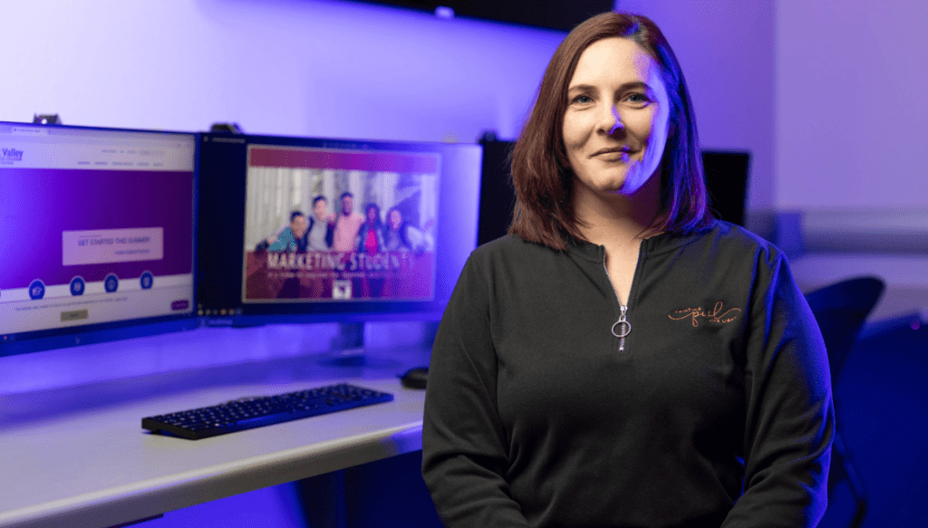 a woman standing in front of a computer