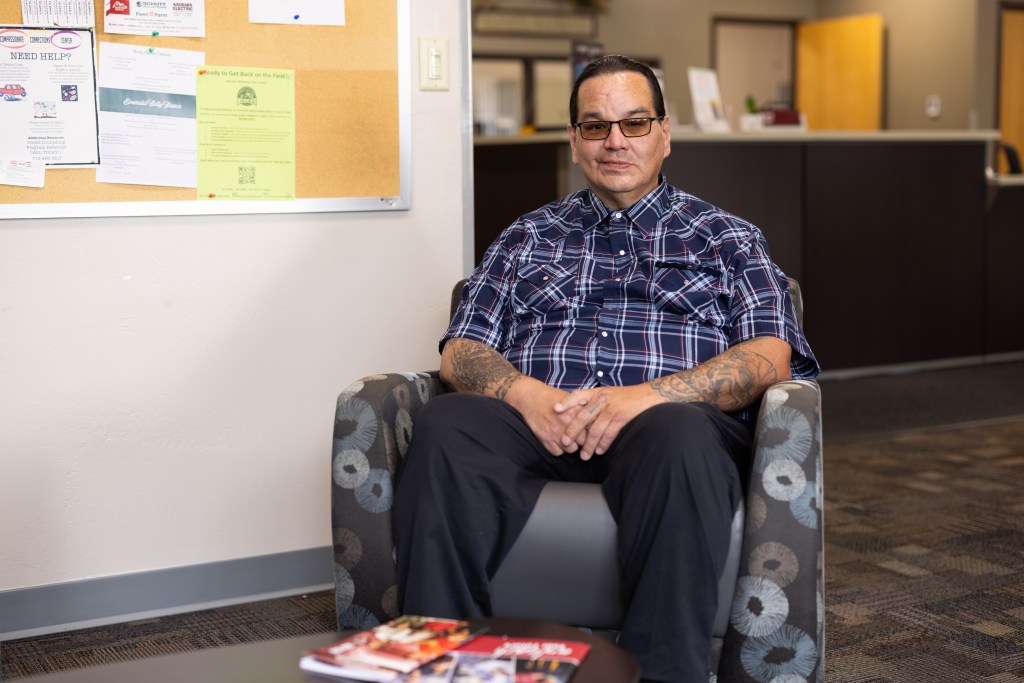 Student smiling in a lobby.