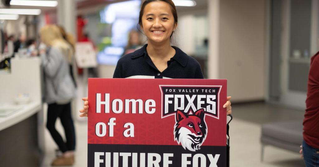student holding sign