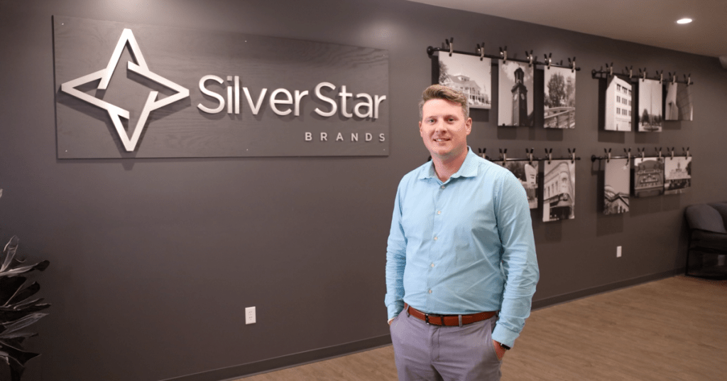 Travis Draeger in front of Silver Star Brands sign