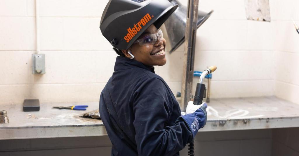 Welding student in shop