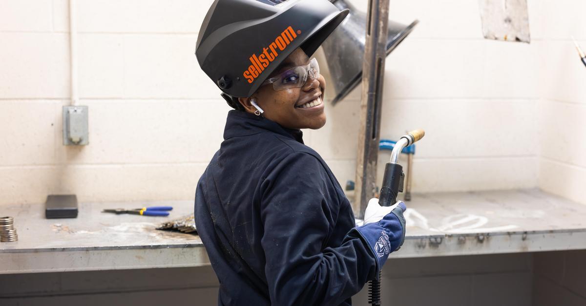 Welding student in shop