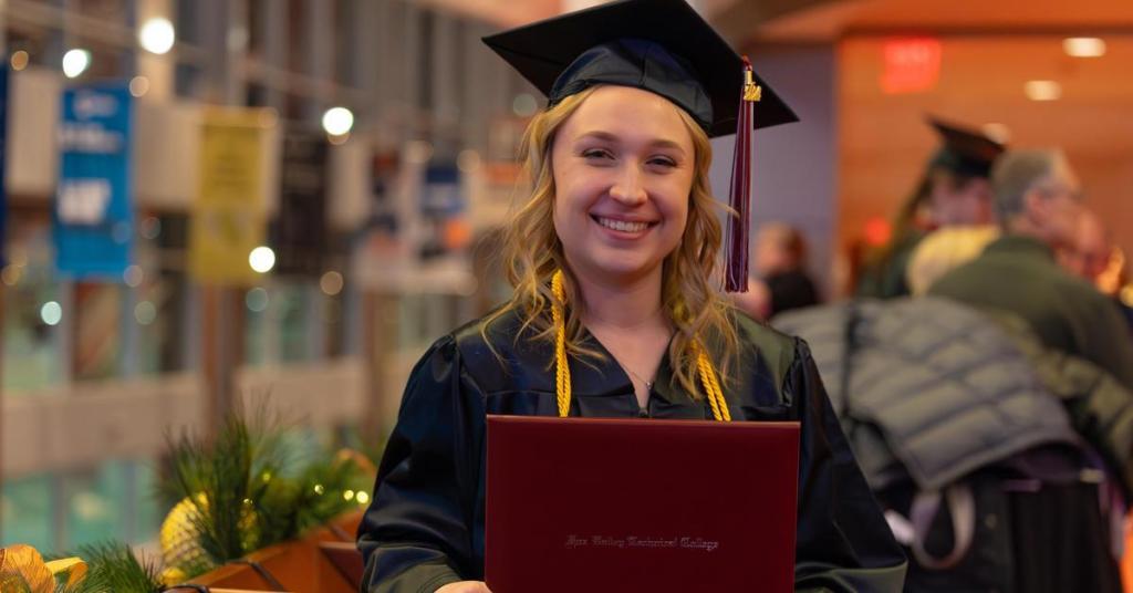 Female graduate holding diploma