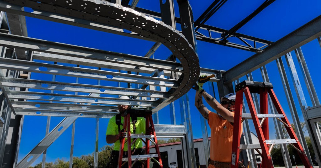 Construction students working on metal structure