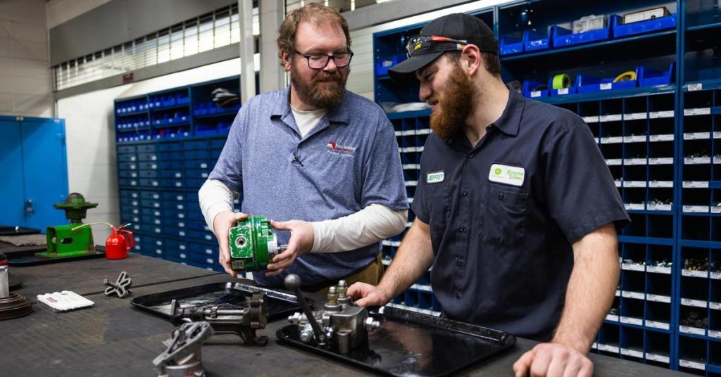 Faculty Spotlight Justin Wege in an agriculture lab, working with a student.