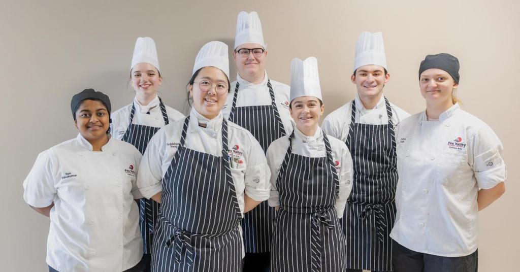 Culinary competition team students smiling.