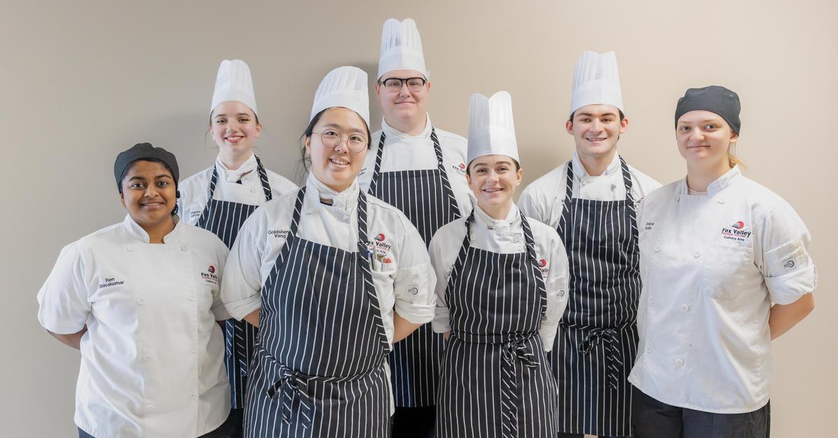 Culinary competition team students smiling.