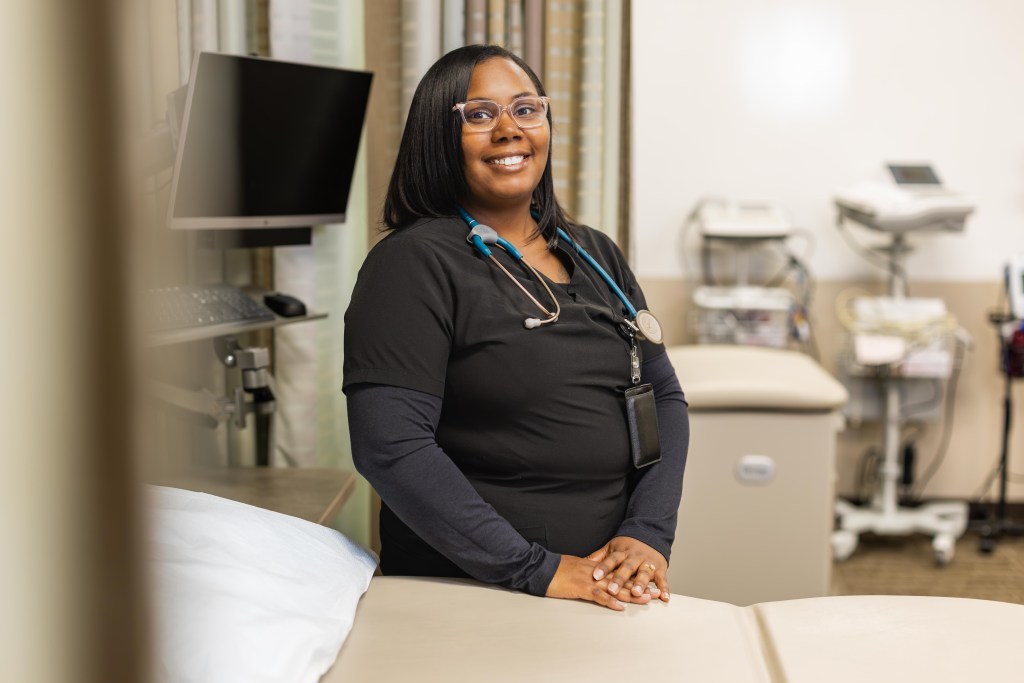 Janay Curtis smiles in a medical lab. 