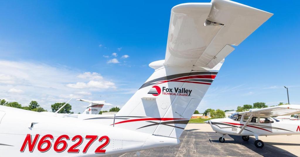 The Fox Valley Technical College aviation fleet is parked outside the hangar.